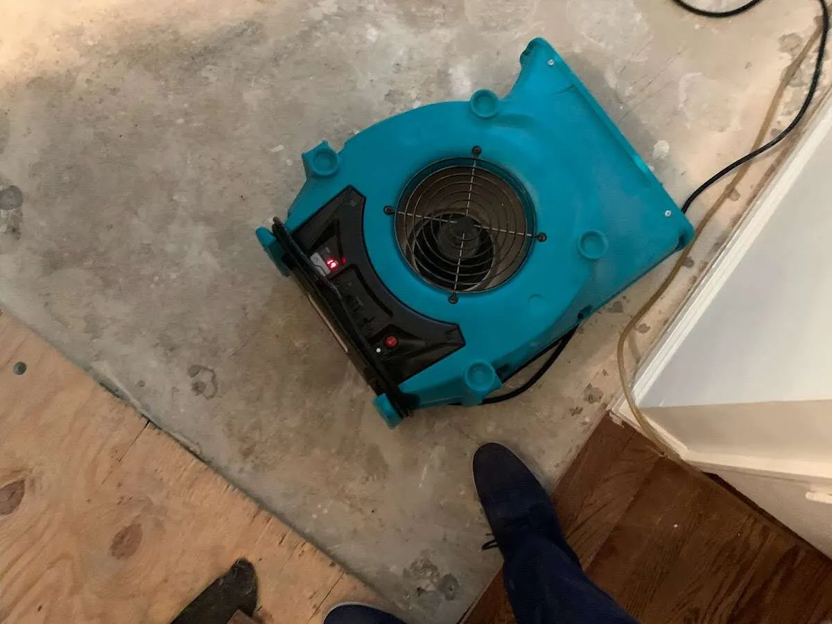 Air mover drying subfloor during Leak Detection & Repair in Hollymead